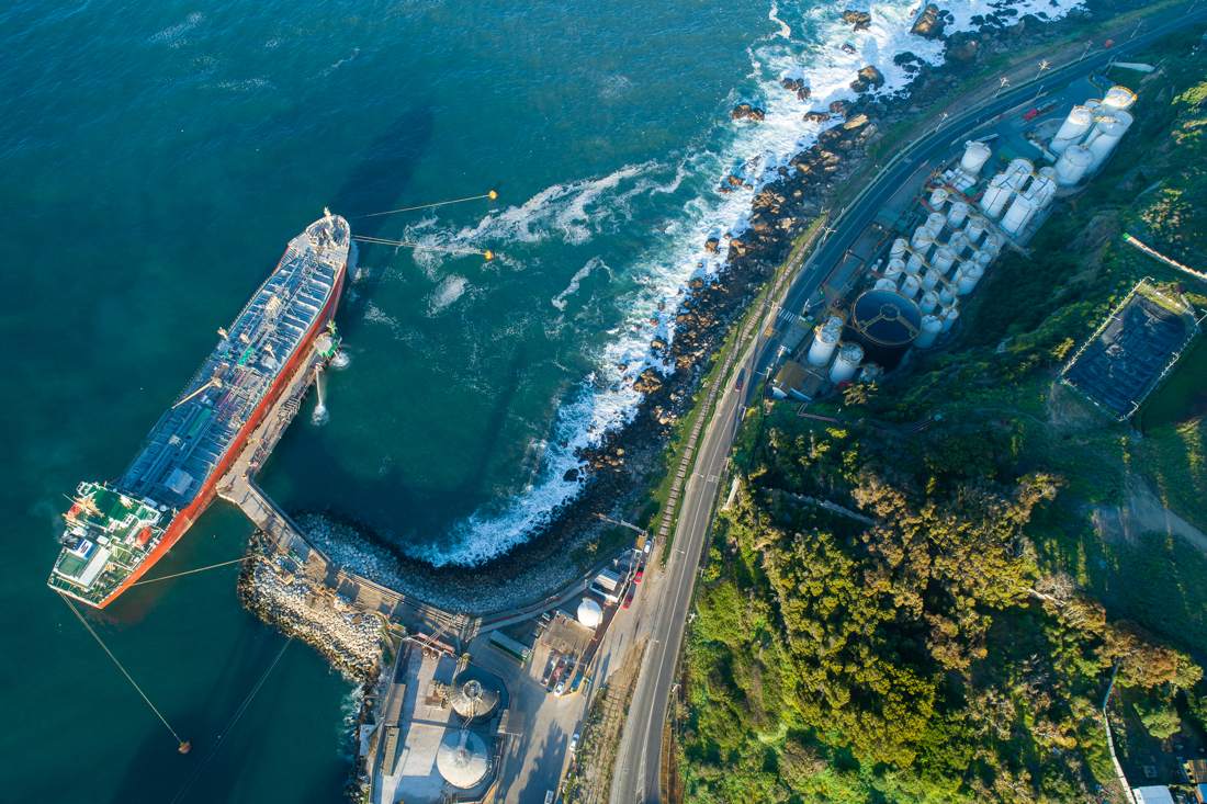Vista aérea del muelle y el área de respaldo con estanques de almacenamiento